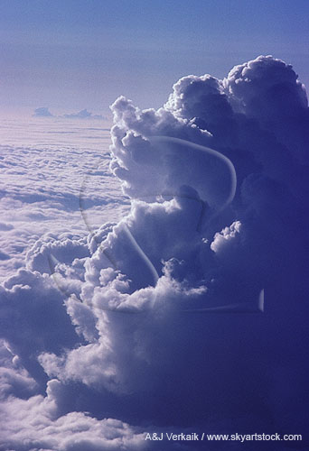 Towering Cumulus cloud viewed at eye level from an airplane