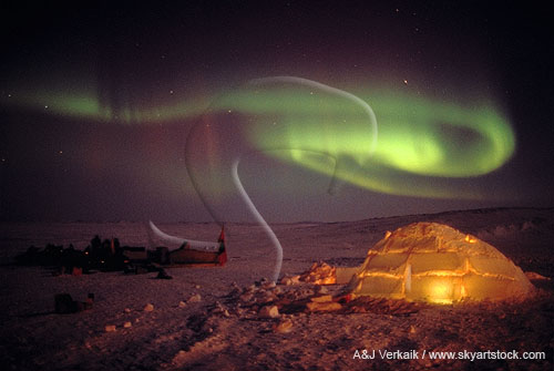 Aurora over a lit up Inuit igloo in the Northern Canada arctic