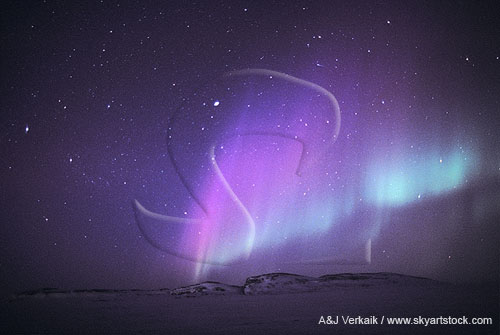 Brilliant purple and red Aurora Borealis edged with green