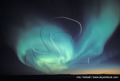 A whirling circle of blue-green northern lights 