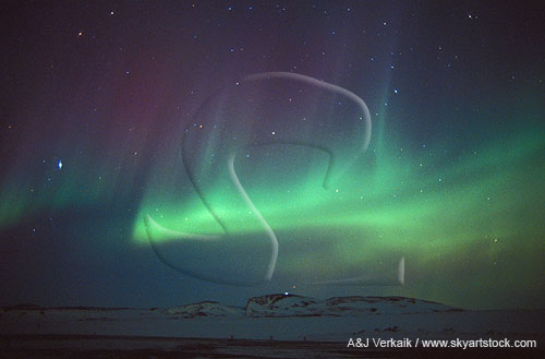 Streaks and bands of red and green northern lights (Aurora Borealis)