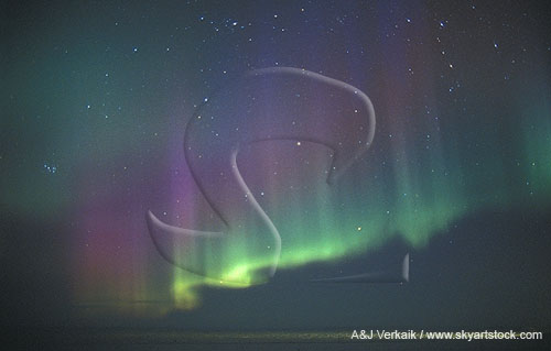 Curtain of colorful aurora in a star-filled arctic sky