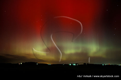 Mystery stirs the night sky as red Aurora hover among the stars