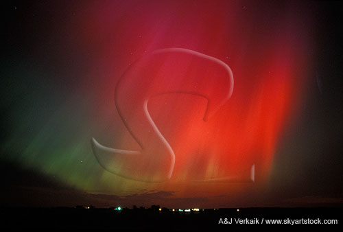 Avenging angel: red Aurora Borealis in the night sky