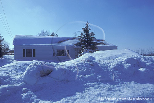 A house hidden behind heavy snowfall