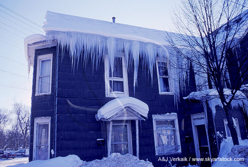 Large icicles hang from a poorly insulated house