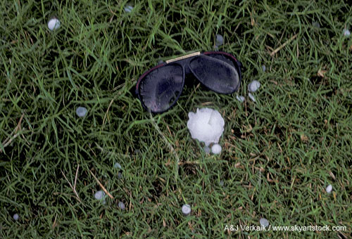 Sparsely scattered hailstones, small and large