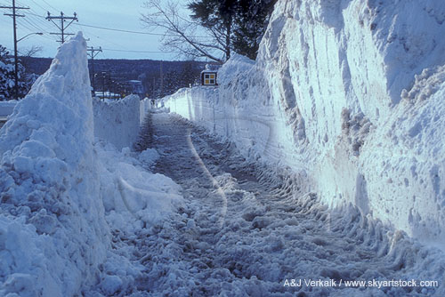 Deep opening cut for sidewalk through very high snowbanks