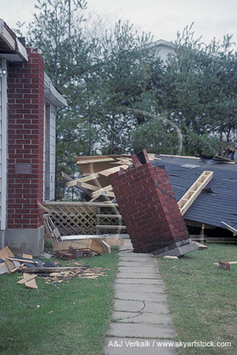 The chimney torn off a house damaged by a tornado