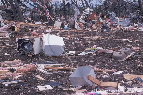 Tornado debris field with sinks, appliances and clothing