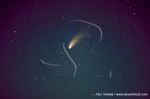 Comet Hale-Bopp streaks through the deep blue night sky with stars