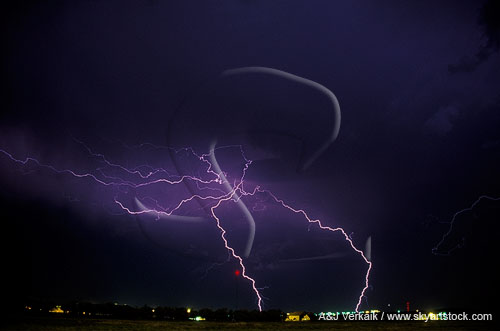 Lightning strikes and filaments over a town