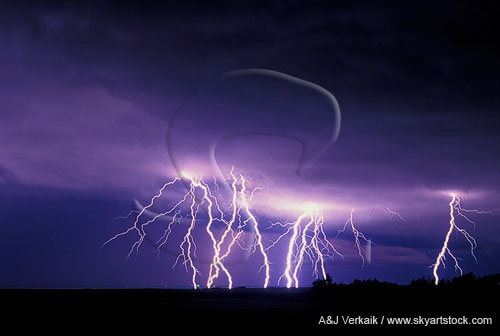 Multiple cloud-to-ground lightning bolts cast eerie light 