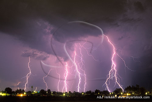 Multiple cloud-to-ground lightning over city lights