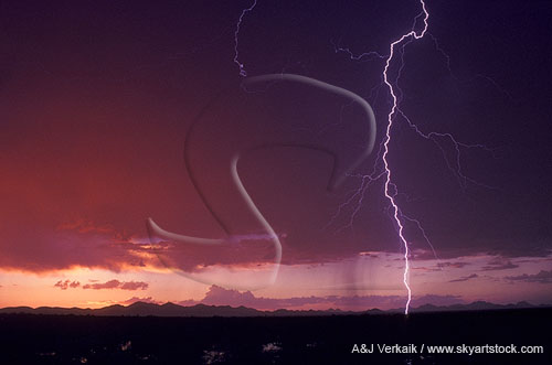 A single lightning bolt strikes in a blood-red desert sky