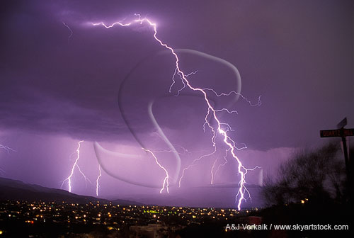 A brilliant close lightning bolt with misty distant bolts