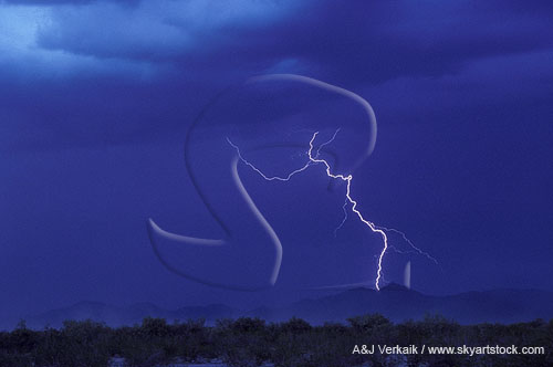 A single ghostly lightning bolt strikes in the mountains