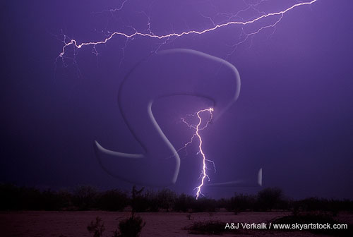 A branching arm of horizontal lightning flashes over a distant bolt
