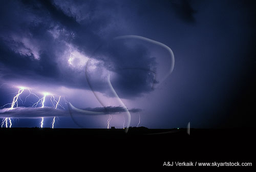 Lightning bolts strike through low clouds in a haunting stormy sky