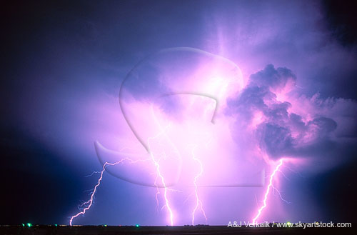 An explosion of power bolts of lightning electrifies the night sky