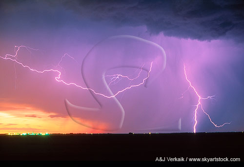 Display of lightning in a red and purple sunset 