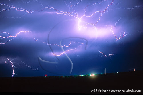 Short segments of horizontal lightning dart in and out of the cloud layer 