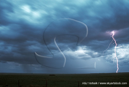 A single daylight lightning bolt in a turbulent sky