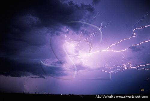 A spray of horizontal lightning springs far out from a storm cloud