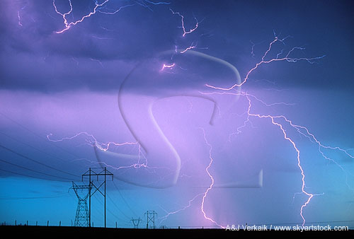 Electricity, wild and tame, with lightning over transmission towers