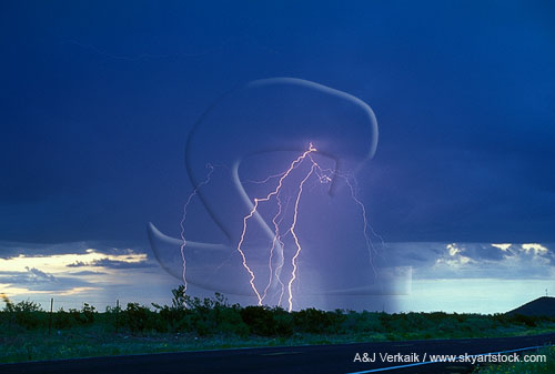 Fine cloud-to-ground lightning in daylight with a rain shower