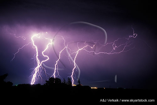 Brilliant highly electric lightning bolts rip through the night sky
