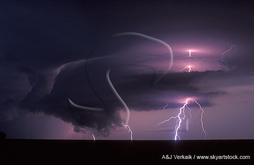 Supercell with lightning at night with a ragged wall cloud