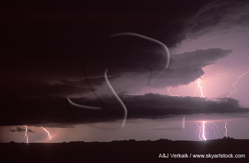 Storms clouds silhouetted by brilliant lightning