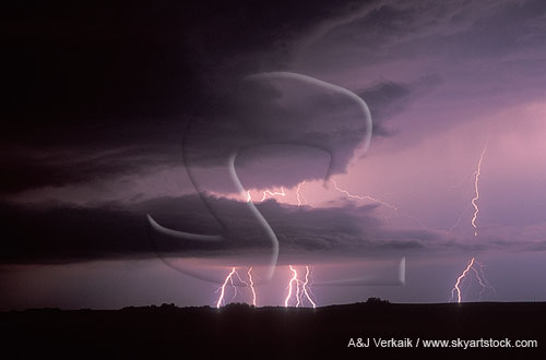 Distant lightning bolts light up storm clouds