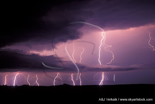 Under a storm with lightning strikes behind a beaver tail cloud