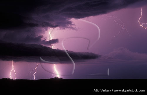 A brilliant lightning bolt pierces through the base of a storm 
