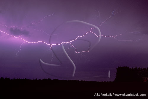 A cloud-to-air lightning channel spreads through the air