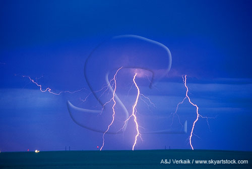 Three lightning bolts glow pink against the daytime sky