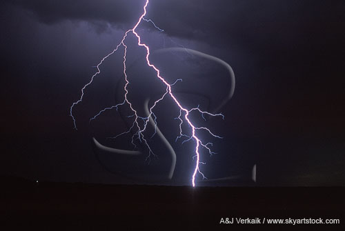 A blazing close thunderbolt with forks and colored lightning filaments.