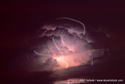 Intracloud lightning illuminates the dome of a storm cloud like a light bulb