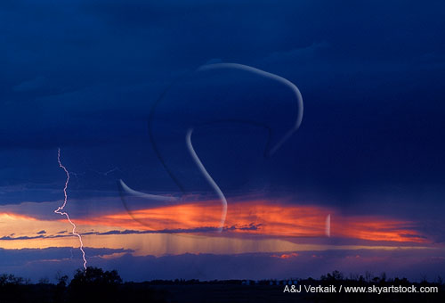 A finely etched lightning strike in a fire-red sunset sky