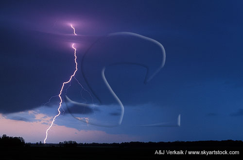 Close-up of a single cloud-to-ground lightning bolt at twilight