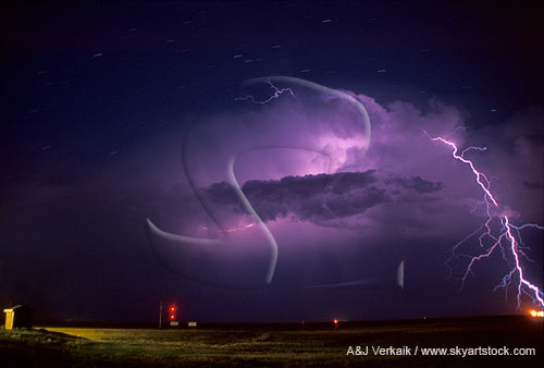 Brilliant lightning strikes out from the top of a storm cloud