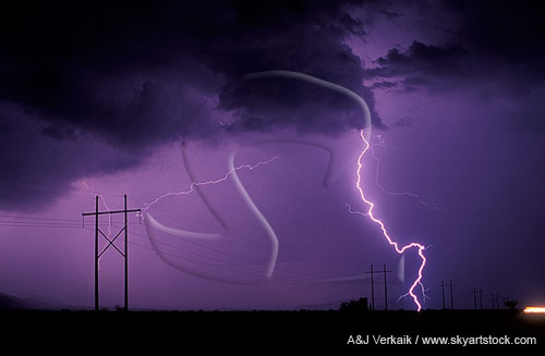 A storm drops an electric lightning bolt in a power corridor