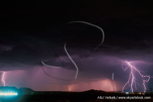 Forked lightning strikes under heavy storm clouds