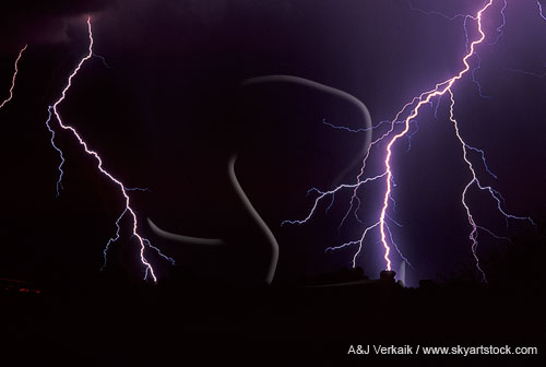A close-up of brilliant forked lightning with a sheen of light
