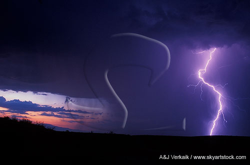 A single, high current lightning bolt burns against a dark storm