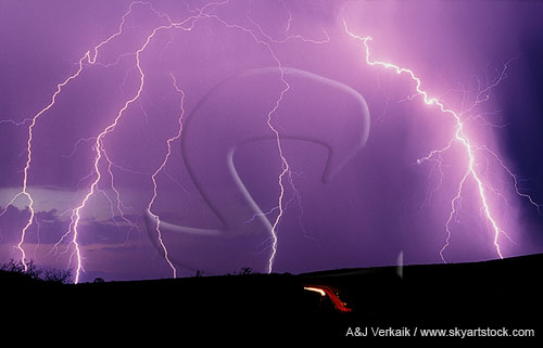 Brilliant, searing lightning bolts in a twilight sky