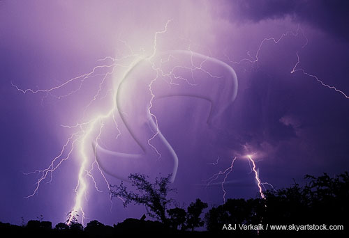 A close, white-hot lightning bolt rips through the sky