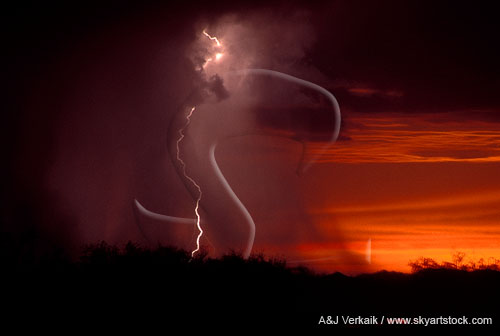 Exquisite lightning with a dusky rain shaft in a rich red sunset sky